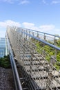 Stairway to heaven - steel staircase going up to a blue sky with clouds Royalty Free Stock Photo