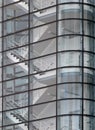 Stairways between the floors of a futuristic modern commercial building behind a curved glass facade