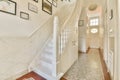 the stairwell of a home with white marble walls Royalty Free Stock Photo