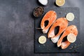 Stake Fish trout with lemon and spices on dark background