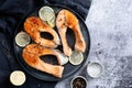 Stake Fish trout with lemon and spices on dark background