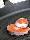 Stake of salmon on pan