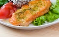 Stake from a salmon with vegetables . Closeup.