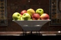 Staked red and green apples in a bowl