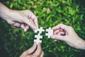 Stakeholders business team holding jigsaw puzzle as a team building and organization connection symbol. Teamwork and connection Royalty Free Stock Photo