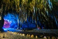 Stalactite in cave interior with color light at Khao Bin cave