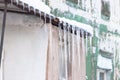 Stalactites on old green house in winter time