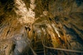 Pathway along stalactites and stalagmites formations in Demanovska cave of Liberty, Slovakia, geological rocks background