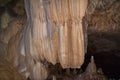 stalactites and stalagmites in an underground deep cave, formations on rocks and rock under the influence