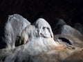Stalagmite in a cave with ghost shape Royalty Free Stock Photo