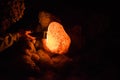 Stalagmite in flashlight beams.