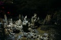 Stalagmite in large dark scary hall of underground natural cave