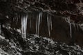 Stalagmites and stalactites inside the underground glacier in Scarisoara glacier cave. Royalty Free Stock Photo