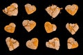 Stale, dry gingerbreads in shape of heart with cracked glaze with crumbs. Isolated on black background. Confectionery. Sweet