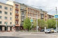 Stalin-era apartment building with offices and shops in the basement on the spring city street.
