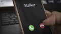 Stalker caller. A man holds a phone in his hand and thinks to end the call. Incoming from an unknown number at work. Incognito or