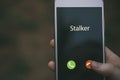 Stalker caller. A woman holds a phone in his hand and thinks to end the call. Incoming from an unknown number. Incognito or