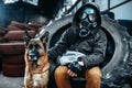 Stalker in gas mask and dog, post-apocalypse