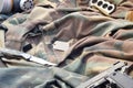 Stalker soldiers soviet gas mask lies with handgun and knife on green khaki camouflage jackets Royalty Free Stock Photo