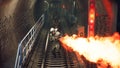 Stalkers in chemical protective clothing walk along an abandoned subway with a flamethrower during a virus epidemic. The Royalty Free Stock Photo