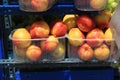 Stall with peaches in plastic boxes at street market Royalty Free Stock Photo