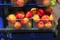 Stall with peaches in plastic boxes at street market Royalty Free Stock Photo