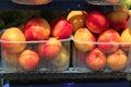 Stall with peaches in plastic boxes at street market Royalty Free Stock Photo