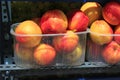 Stall with peaches in plastic boxes at street market Royalty Free Stock Photo