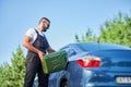 Stalled car filling with gasoline by professional worker.