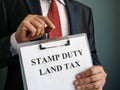 Stamp duty land tax concept. The manager holds the papers.