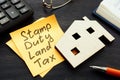 Stamp duty land tax SDLT memo and model of home.