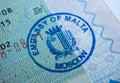 Stamp of the embassy of Malta in passport. Made by immigration officer at Maltese embassy in Moscow. Selective focus. Macro photo