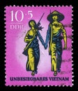 Stamp issued in Germany - Democratic Republic DDR shows Couple with arms Invincible Vietnam