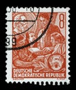Stamp issued in Germany - Democratic Republic DDR shows Learning youth, Karl Marx picture in the background Royalty Free Stock Photo