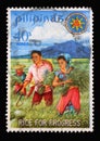 Stamp issued in the Philippines shows President and Mrs. Marcos harvesting miracle rice Series: Rice for Progress