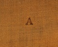 Stamp letters on linen fabric. Letter A.