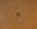 Stamp letters on linen fabric. Letter H.