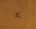 Stamp letters on linen fabric. Letter Y.