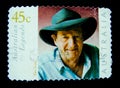 A stamp printed in Australia shows an image of Slim Dusty Australian country music singer-songwriter, guitarist and producer.