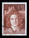 Stamp printed by Austria, shows image portrait of famous Austrian Baroque architect Jakob Prandtauer against Melk Abbey Church