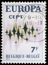 Stamp printed in Belgium showing sparkling stars on a white background
