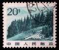 Stamp printed in China shows image of Chinese highland with pine trees in Tianshan Mountain