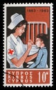 Stamp printed in Cyprus shows Centenary International Red Cross - Nurse tending child