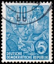 Stamp printed in GDR, shows Farmer and workers Royalty Free Stock Photo