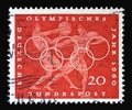 Stamp printed in Germany showing Discus and javelin throw, Olympic rings and promotes 17th Olympic Games in Rome