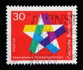 Stamp printed in Germany showing a five-pointed colorful star, 50 years of the International Labor Organization