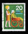 Stamp printed in Germany showing a helper pushes a wheelchair, Volunteer Nursing Aid