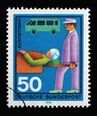 Stamp printed in Germany showing a rescuer carries injuries into a stretcher, volunteer emergency service accident protection