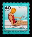 A stamp printed in Germany shows Rowing, single sculls, Youth training for the Olympics