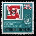 Stamp printed in Indonesia, shows emblem of International Labour Organization and UN